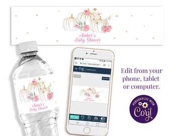 May include: Water bottle label with a white background and gold glitter. The label features a watercolor illustration of white pumpkins with pink flowers and green leaves. The text "Amber's Baby Shower" is written in pink and gold letters.