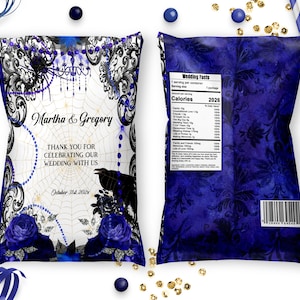 May include: A decorative snack bag with a dark blue and white design, featuring the names "Martha & Gregory" and the text "Thank you for celebrating our wedding with us". The bag has a floral and spiderweb theme.