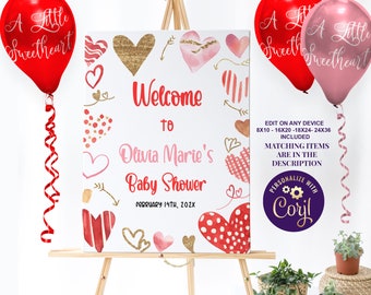 May include: Welcome to Olivia Marie's Baby Shower sign with pink and red hearts, gold glitter accents, and the date February 14th, 202X. The sign is on an easel with red and pink balloons.