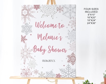 May include: Welcome to Melanie's Baby Shower sign with a pink and silver snowflake design. The sign is available in four sizes: 8x10 inches, 16x20 inches, 18x24 inches, and 24x36 inches.