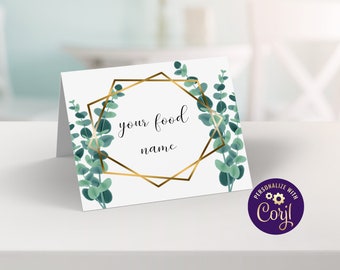 Puede incluir: Tarjeta blanca con un marco geométrico dorado y hojas de eucalipto verdes. El texto "your food name" está dentro del marco. La tarjeta está sobre una superficie blanca. El texto "Personalizar con Caryl!" está en un círculo morado con engranajes dorados.