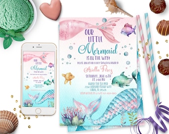 May include: A baby shower invitation with a watercolor illustration of a mermaid tail with pink and blue scales. The text reads "Our Little Mermaid is on the way!" and includes the date, time, and location of the event.