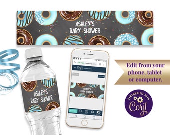 May include: Water bottle label with a donut theme. The label is black with white sprinkles and features blue and brown donuts with white frosting. The text on the label reads "Ashley's Baby Shower".