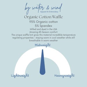 May include: A light blue graphic with text describing organic cotton waffle fabric. The text includes "by water & wind", "Organic Cotton Waffle", and details about the fabric's composition and properties. A gauge indicates "Midweight" fabric.
