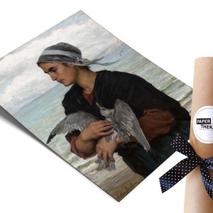 May include: A vintage painting of a woman in a blue and white headscarf holding a seagull in her arms. The woman is standing on a beach with the ocean in the background. The painting is signed "Jules Breton".