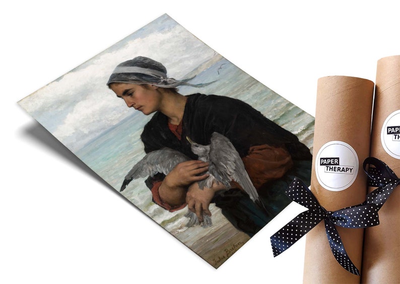May include: A vintage painting of a woman in a blue and white headscarf holding a seagull in her arms. The woman is standing on a beach with the ocean in the background. The painting is signed "Jules Breton".