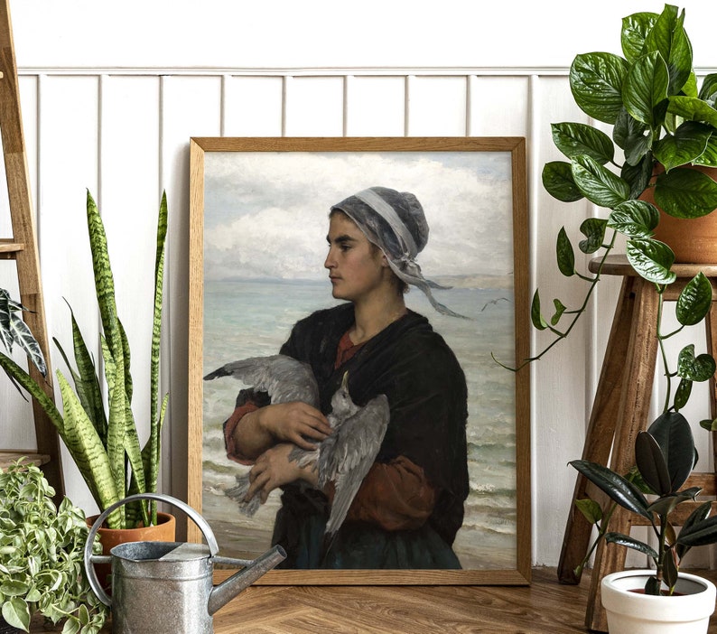 May include: A painting of a woman in a blue and white headscarf holding a white bird in her arms. The woman is wearing a dark brown dress and is standing in front of a body of water. The painting is set against a light blue sky with white clouds.