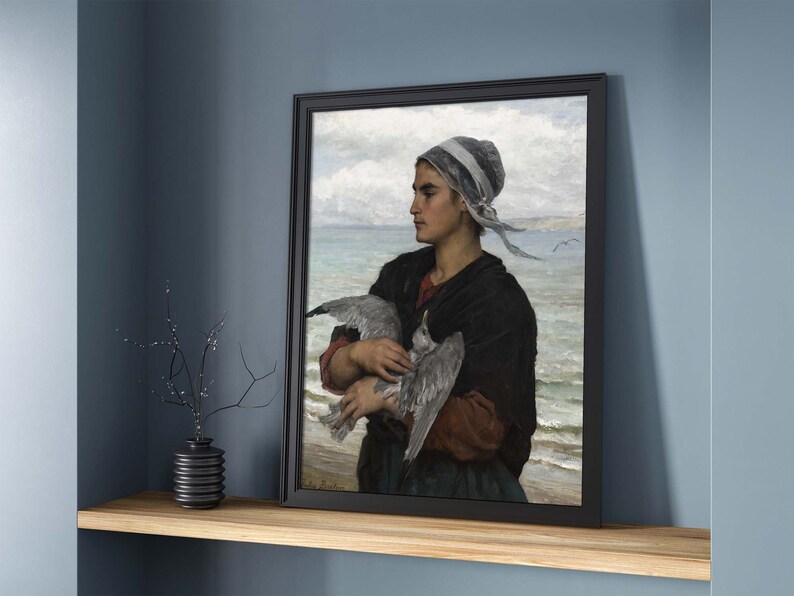 May include: A painting of a woman in a white cap holding a seagull in her arms. She is standing on a beach with the ocean in the background.