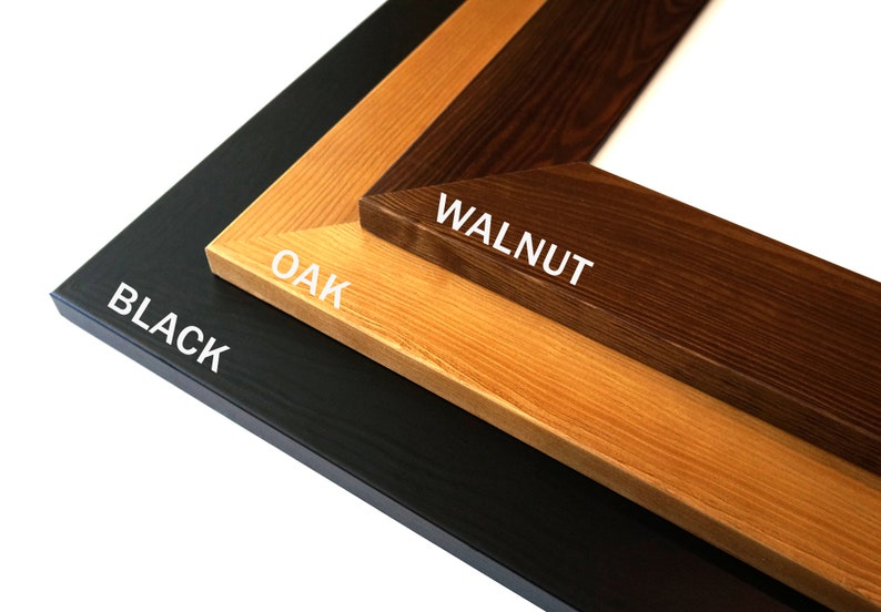 Puede incluir: Primer plano de tres muestras de marcos de fotos de madera: negro, roble y nogal. Se ven las esquinas de los marcos, con la veta de la madera y las variaciones de color claramente mostradas. Los textos "BLACK", "OAK" y "WALNUT" est&aacute;n impresos en cada marco.
