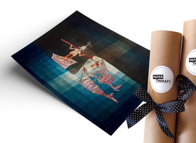 May include: A blue and brown abstract art print featuring a stylized figure in a boat with two fish-like creatures. The print is rolled up and tied with a black ribbon with white polka dots. The ribbon has a white label with the text "PAPER THERAPY".