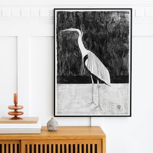 May include: Black and white illustration of a heron standing on a white background. The heron has a long neck and long legs. The illustration is framed in a black frame.