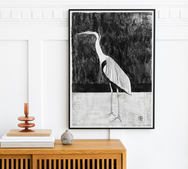 May include: Black and white illustration of a heron standing on a white background. The heron has a long neck and long legs. The illustration is framed in a black frame.