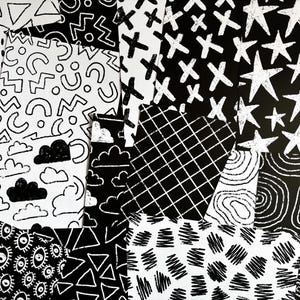 May include: A collection of overlapping rectangular papers featuring various black and white hand-drawn patterns including stars, clouds, grids, triangles, circles, squiggles, and eye motifs, creating a dense collage of high-contrast graphic designs.