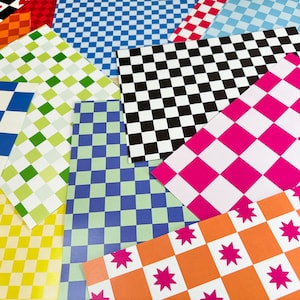 May include: An assortment of patterned papers featuring a variety of designs. The patterns include checkered, diamond, and starburst motifs in colours such as black, white, pink, blue, green, orange, and yellow. The papers are arranged overlapping.
