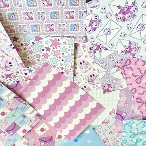 May include: A selection of patterned papers in diverse designs and colours. Patterns feature ghosts, envelopes, stars, bows, and scalloped stripes. Colours include pink, purple, blue, and white. These papers are likely for crafts or stationery purposes.