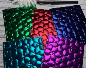 May include: Five sheets of metallic paper with a floral embossed pattern. The sheets are in shades of green, red, blue, teal, and purple.