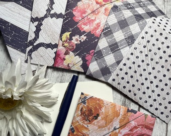 May include: A set of six decorative envelopes with different patterns, including floral, geometric, and polka dot designs. The envelopes are made of paper and have a distressed, vintage look.