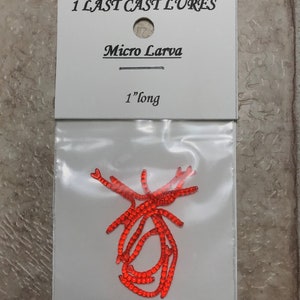 May include: A package of Micro Larva fishing lures. The lures are bright orange and are approximately 1 inch long. The package has the text "1 LAST CAST LURES" and "Micro Larva" printed on it.