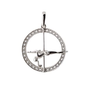 May include: A silver pendant featuring a stylised figure performing a pole dance inside a circle of sparkling diamonds.