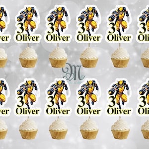 May include: Twelve cupcake toppers featuring a cartoon image of Wolverine from the X-Men comics. Each topper has a yellow and blue Wolverine character with the number 3 and the name Oliver printed below.