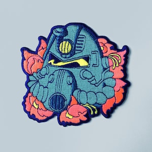May include: An embroidered patch featuring a blue and green power armour helmet with a yellow visor, surrounded by pink and orange flowers.