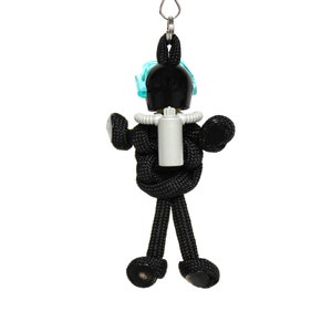 May include: Black paracord keychain with a black and white figure wearing a blue diving mask and a white oxygen tank.