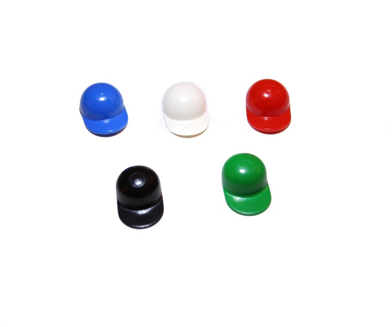 May include: Five miniature baseball caps in different colors: blue, white, red, black, and green.