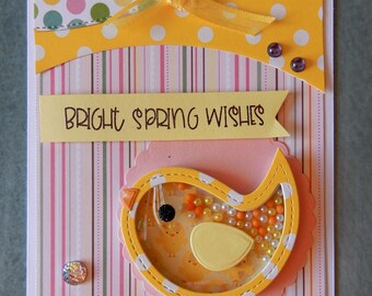 Hand made spring chick shaker card. A cute chick proclaims Bright Spring Wishes. 5.5 inch by 4.25 inch. 3 Dimensional card with envelope