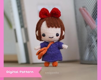 May include: Crochet amigurumi doll pattern of a girl with brown hair, a red bow, a purple dress, and an orange bag. The doll is standing on a wooden surface. The text "Digital Pattern" is visible in the image.