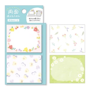 May include: A pack of colorful floral patterned sticky notes. The pack includes three different designs: a wreath of flowers, a scattering of small flowers, and a green field with a circle of daisies. The text on the pack reads "両面 使えるふせん 30 sheets × 2 好きな位置・方向に 貼ることができる!"