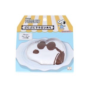 May include: A Snoopy-shaped macaron memo pad, packaged on a white plate. The pad features a white Snoopy design with brown accents, and the packaging includes Japanese text and the Peanuts logo.