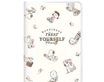 May include: A white rectangular notebook cover featuring brown line art illustrations of Peanuts characters eating ice cream. The center text reads HAPPINESS TREAT YOURSELF Peanuts. The design includes Snoopy, Charlie Brown, and friends.