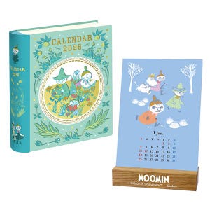 May include: A 2026 calendar set featuring Moomin characters. The set includes a hardcover book-style calendar and a desk calendar with a wooden base. The book calendar is light green with illustrations and the text "CALENDAR 2026". The desk calendar is light blue.