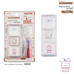 May include: A Hancoco slide layer stamp set featuring Snoopy. The packaging includes three square stamps with blue, brown, and red ink designs of Snoopy and a doghouse, along with two small plastic tools in pale violet and dark red for sliding.