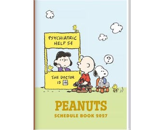 May include: A 2027 Peanuts schedule book featuring a light blue and green cover with a Peanuts comic illustration. The graphic shows Lucy in a yellow psychiatric help booth, Charlie Brown, Snoopy, and Woodstock. The text reads: PSYCHIATRIC HELP 5¢, THE DOCTOR IS IN, PEANUTS, and SCHEDULE BOOK 2027.