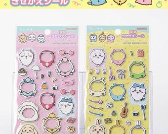May include: Two packs of stickers featuring cartoon characters in various costumes. The stickers are on pink and yellow backgrounds with Japanese text. The stickers include food, musical instruments, and other accessories.