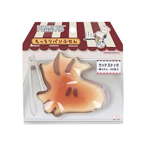 May include: A package of Peanuts-themed sticky notes shaped like Woodstock, with a bread-like appearance. The packaging features the Peanuts logo, text in Japanese, and an illustration of Snoopy as a chef. Includes a small plastic tweezer.