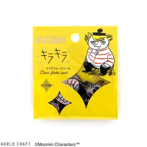 May include: A yellow package with a clear plastic window showing a sheet of Moomin character stickers. The stickers are in the shape of stars and feature a Moomin character wearing a striped shirt and a hat. The package has Japanese text that says "Moomin" and "Clear flake seal".