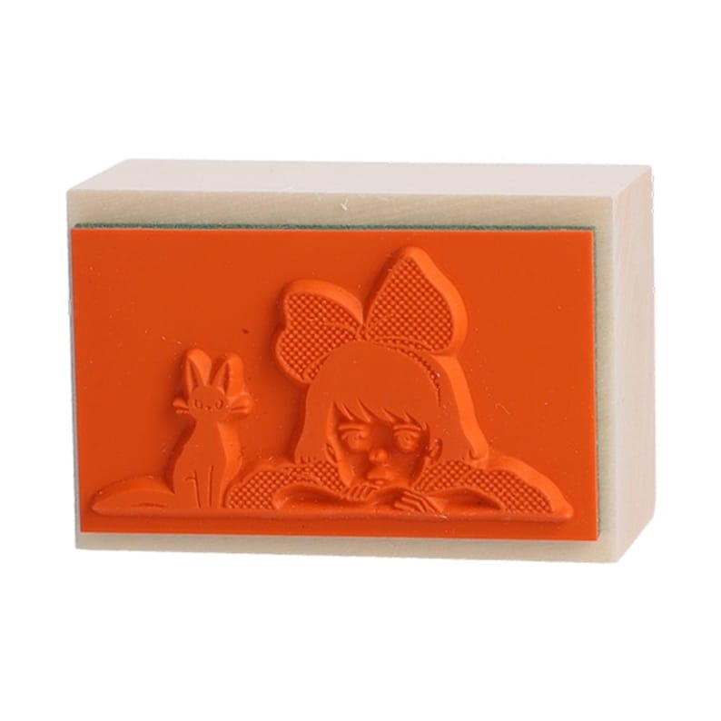 May include: A wooden stamp with an orange rubber surface. The design on the stamp is a girl with a bow in her hair and a cat beside her.