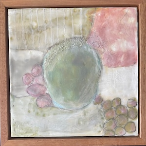 May include: A framed abstract painting with a green circle, pink and white shapes, and a textured background.