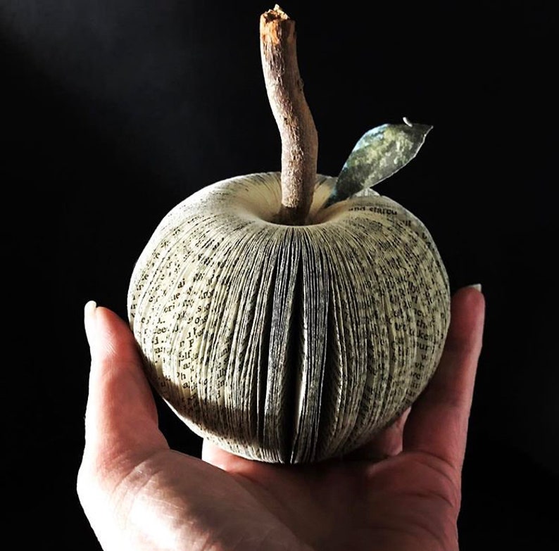 Sculptural apples made from recycled books. A real branch is used for their stems.