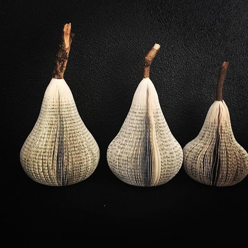 Sculptural pears made from recycled books. A real branch is used for their stems.
