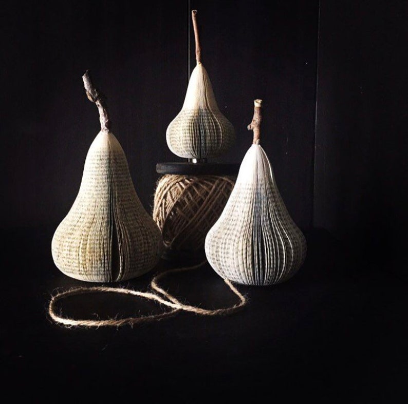 Sculptural pears made from recycled books. A real branch is used for their stems.