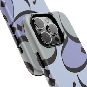 May include: Close-up of two phone cases. The cases feature a light blue background with a repeating pattern of black and lavender shapes. The phone case on the right has a black camera lens protector.