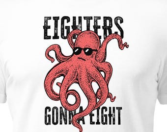 May include: White t-shirt featuring a red octopus wearing sunglasses. The shirt has the text "EIGHTERS GONNA EIGHT" in a distressed black font. The octopus design is a humorous graphic.