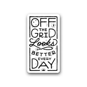 May include: A rectangular white sticker with black text that reads "OFF THE GRID LOOKS BETTER EVERY DAY." The text is in a handwritten style with decorative elements like stars, a moon, and a sun.