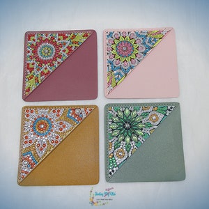 May include: Four colourful corner bookmarks with a diamond-shaped design. Each bookmark has a different colour background and a different diamond-shaped design with rhinestones.
