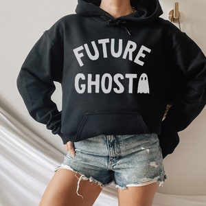 May include: Black hooded sweatshirt with the text "FUTURE GHOST" in white lettering and a white ghost graphic.