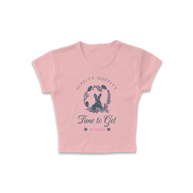 May include: A pink cropped t-shirt with a graphic of a bunny rabbit inside a wreath with the text "Hippity Hoppity Time to Get Zooted".