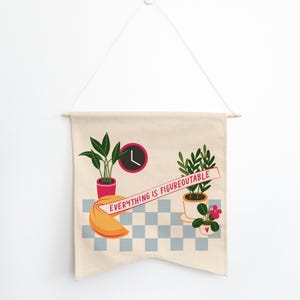 May include: A beige canvas banner with a checkered pattern and the text "Everything is Figureoutable" in red. The banner features a fortune cookie, a clock, and three potted plants, including a pink flower.